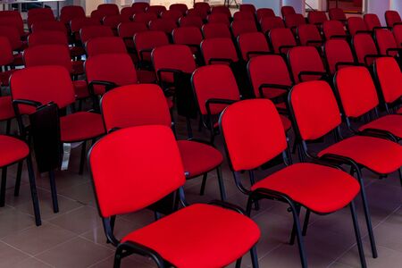 Conference room with a red stage and red chairs for events, conferences and seminarsの写真素材