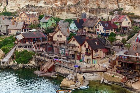 View of the famous village of Popeye with colorful wooden houses and the Gulf of Malta.の写真素材