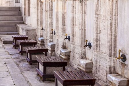 Old metal taps in the wudu-ablution area located in the courtyard in Turkey, Alanya.