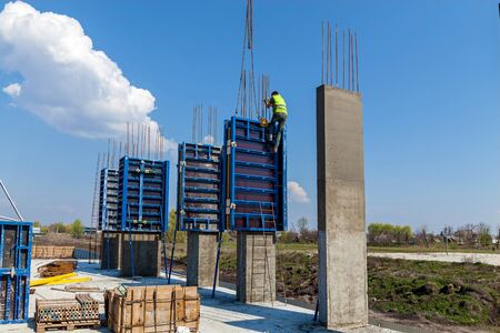 The creation of the base of the high-rise buildings using special columns. Concrete columns with...