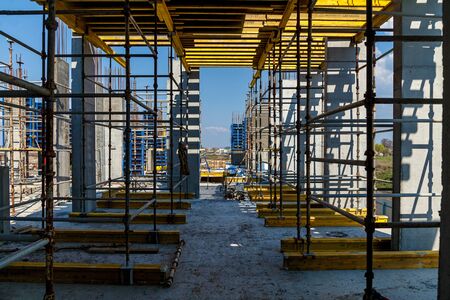 The creation of the base of the high-rise buildings using special columns. Concrete columns with iron coating stand on the big plates.の写真素材