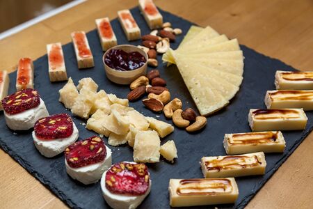 Different types of cheese at a presentation from cheese makers. Top view of a cheese plate with blue...