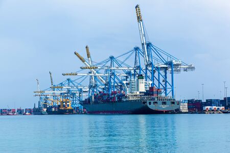 Marsaxlokk, Malta June 17, 2019: A container port and a cargo ship loading plant at the Freeport Terminal Building on the island of Malta.のeditorial素材