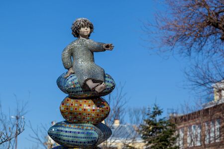 Ukraine Kiev April 9, 2019: Sculptures of an elephant and a small girl at the playground on the background of trees on an autumn sunny day.のeditorial素材