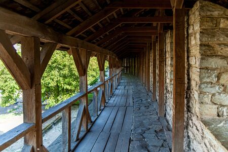 The wooden pathway along a stone wall to the old fortress in Kamyanets-Podilsky, Ukraineの写真素材