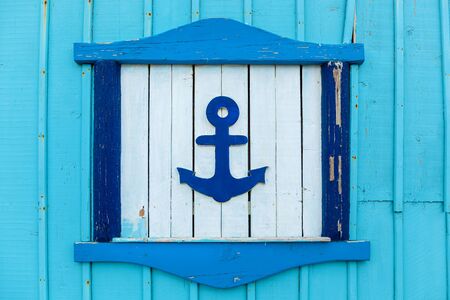The blue wall of a building with decorative elements such as anchors on the white background.の写真素材