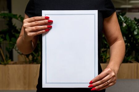 Girl shows blank white A4 paper. . The girl holds offset paper in her hands. A4 paper template for...