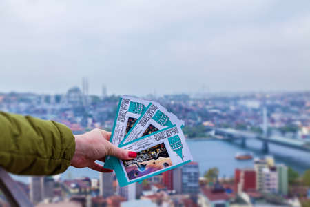 Turkey Alanya April 18, 2018: A woman holding tickets on the background of a city panorama on a...