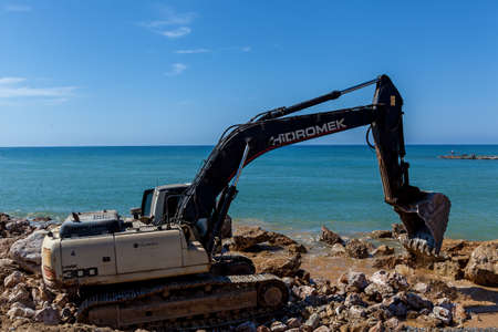 Turkey Alanya April 18, 2018: An old excavator is working on the seashore to prepare it for...