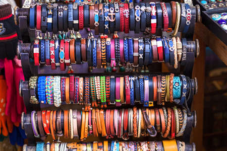 Turkey Alanya April 18, 2018: Handmade traditional colored wristbands are hanging on the special counter at the market, Turkey.のeditorial素材
