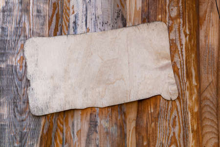 White wooden plaque on a wooden background with an unusual textureの写真素材