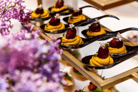 Catering, various delicious desserts on buffet plates. Catering, assorted snacks on plates
