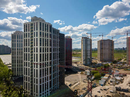 Construction site with multi-storey buildings, tower cranes and construction equipment. construction...