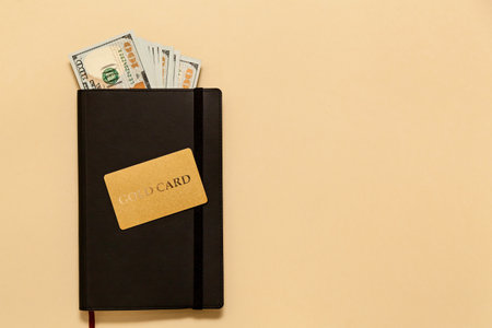 Business concept items on the table diary, dollars, gold card, on a beige background. Bitcoins are a digital currency, the global market for trade and exchange of money.の写真素材