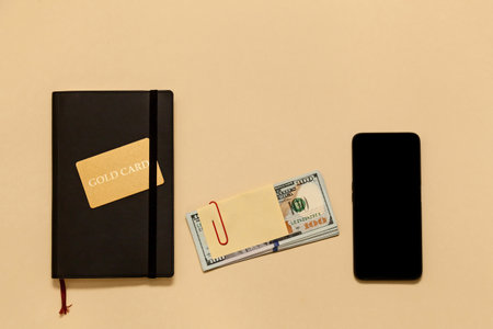 Business concept items on the table diary, dollars, gold card, phone, on a beige background. Bitcoins are a digital currency, the global market for trade and exchange of money.の写真素材
