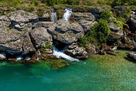Big and fast river turning into waterfall in Podgorica. Landscapes, sights and nature of Montenegro.の写真素材