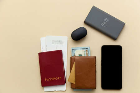 Passport with air tickets and purses with money on a beige background.の写真素材