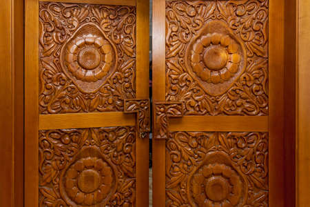 Wooden door with carved handmade patterns, interior detailsの写真素材