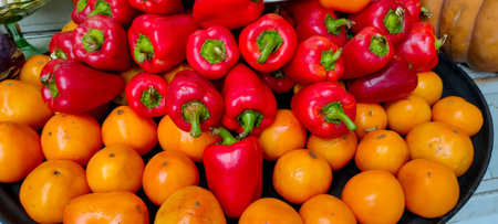 vegetables tomatoes and red peppers on shelvesの写真素材