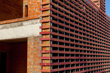 Brick house with a wooden frame for sheathing with metal siding. Cottage town of private houses under construction. Facing houses with sidingの写真素材