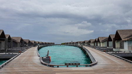 Overwater bungalows and luxury villas in the blue lagoon, on the white sandy beach of Bora Bora island.の写真素材