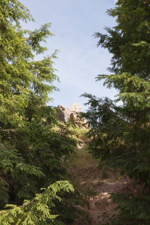 Footpath in a meadow. Stone Hill in the distance. Blue sky with clouds on background.の写真素材
