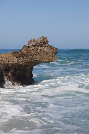 Blue sky, blue sea and surf. Waves, rocks and white sea foam.の写真素材