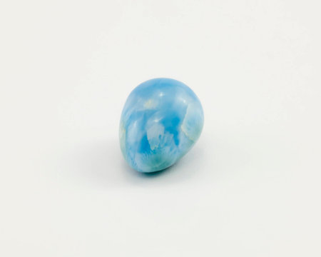 Larimar, also called "Stefilia's Stone", is a rare blue variety of the silicate mineral pectolite found only in the Dominican Republic, an egg shaped on a white background.の写真素材