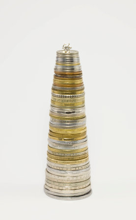 Column of coins with diamond in the form of a Christmas tree on a white background.の写真素材