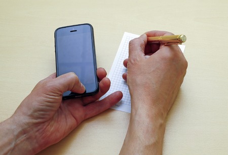 Write a ballpoint pen on a sheet of information paper from your phoneの写真素材