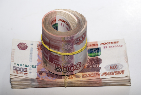 a large pile of money stretched by an elastic bandの写真素材