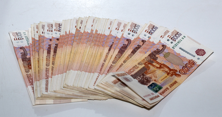 a large pile of money stretched elastic. banknotes of five thousand.の写真素材