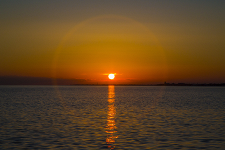 Picturesque bright sunset over the waves of the blue sea in the summer evening. reflection on the water.の写真素材