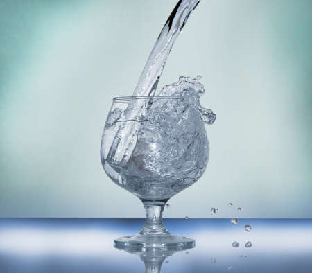 Frozen water splash in a glassの写真素材