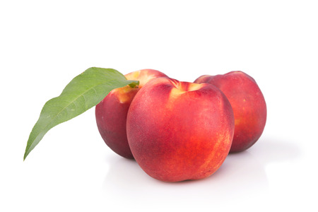 fresh ripe peaches with leaf isolatedの写真素材
