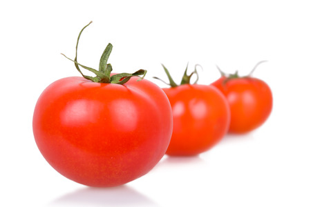 three ripe isolated tomatoesの写真素材