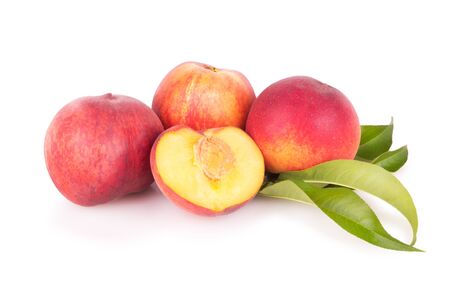 Group of fresh peaches with leaves isolatedの写真素材