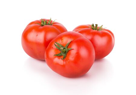three ripe red tomatoes isolatedの写真素材