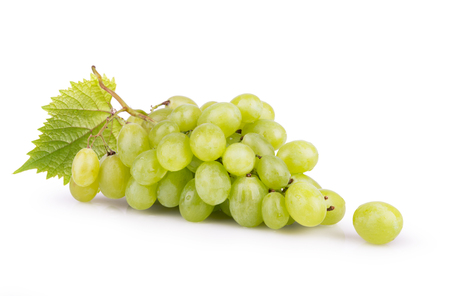 ripe white grapes with leaves isolatedの写真素材