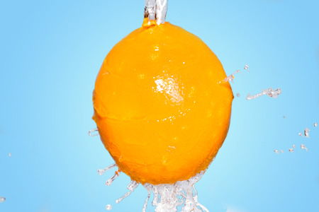 orange under splash of waterの写真素材