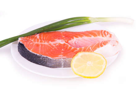 salmon with herbs on a white plateの写真素材