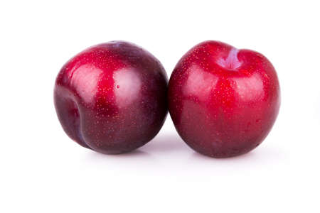 two ripe plums on a white backgroundの写真素材