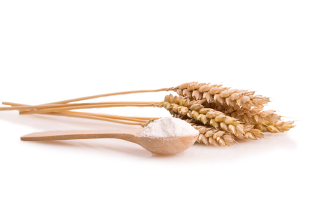 ears of wheat and flour in a spoon isolatedの写真素材
