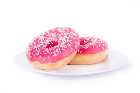 two pink donut on a plate isolatedの写真素材