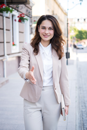 Sincere smiling business girl wants to shake handsの写真素材