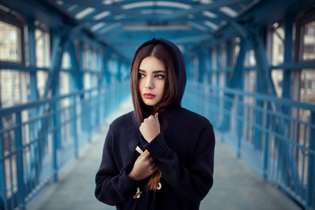 Outdoor fashion lifestyle portrait of pretty young girl, wearing in hipster swag grunge style urban background. Tomboy city conceptの写真素材