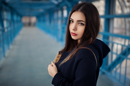 Outdoor fashion lifestyle portrait of pretty young girl, wearing in hipster swag grunge style urban background. Tomboy city conceptの写真素材