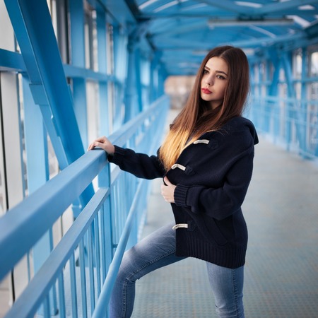 Outdoor fashion lifestyle portrait of pretty young girl, wearing in hipster swag grunge style urban background. Tomboy city conceptの写真素材