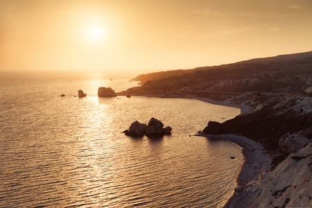 Panoramic sunset landscape of Petra tou Romiou (The rock of the Greek), Aphrodite's legendary birthplace in Paphos, Cyprus island, Mediterranean Sea.の写真素材