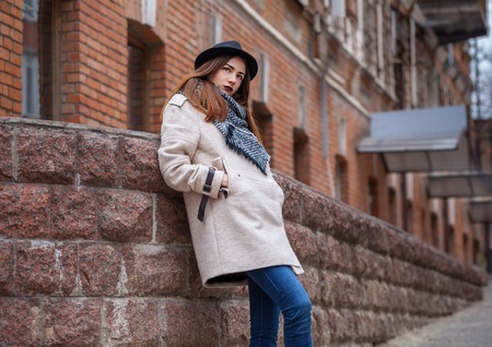 Fashion portrait of glamour sexy romantic lady wearing casual coat, black hat. Cold spring autumn season.の写真素材
